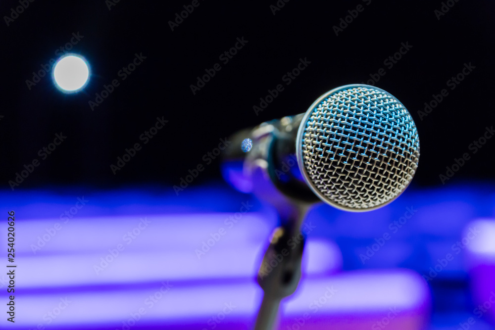 Wireless microphone on stand on blurred background. Empty audience. Wireless microphone on stand on blurred background. Empty audience.