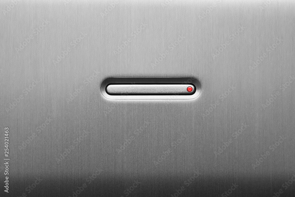 Fotografie The power button on the aluminum panel. Close-up.