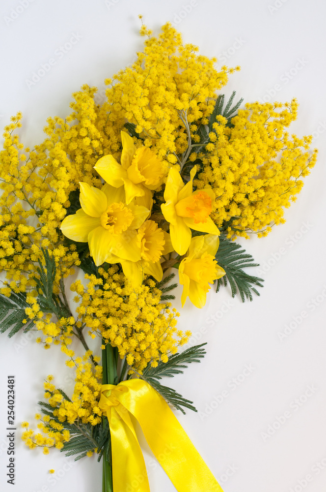 Bouquet of daffodils and Mimosa with a ribbon. It's spring. March 8. Bouquet of daffodils and Mimosa with a ribbon. It's spring. March 8.