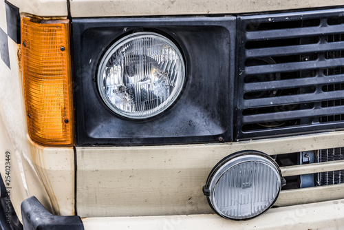 left front light of an old van in yellow