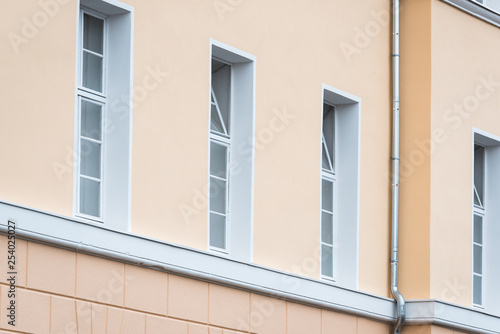 yellow house with four white framed windows