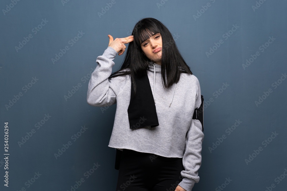 Young sport woman with problems making suicide gesture Young sport woman with problems making suicide gesture
