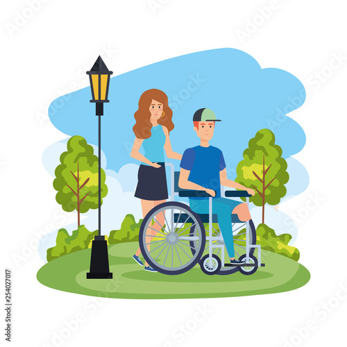 young man in wheelchair with female helper