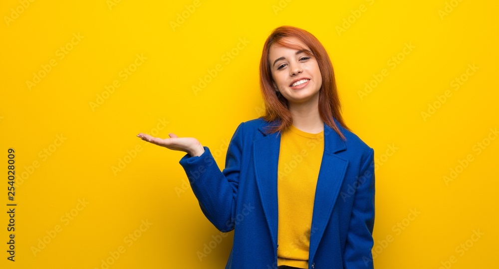 Young redhead woman with trench coat holding copyspace imaginary on the palm to insert an ad Young redhead woman with trench coat holding copyspace imaginary on the palm to insert an ad