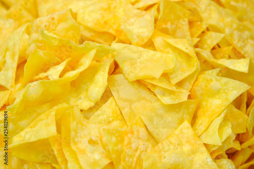 Potato chips with cheese and fragrant ingredients close-up macro