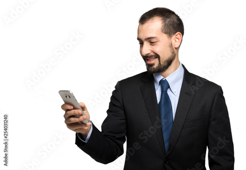 Handsome businessman reading a message on his smartphone, isolated on white