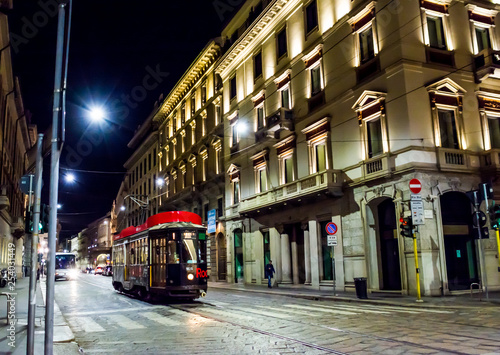 tram on the night street in Milan