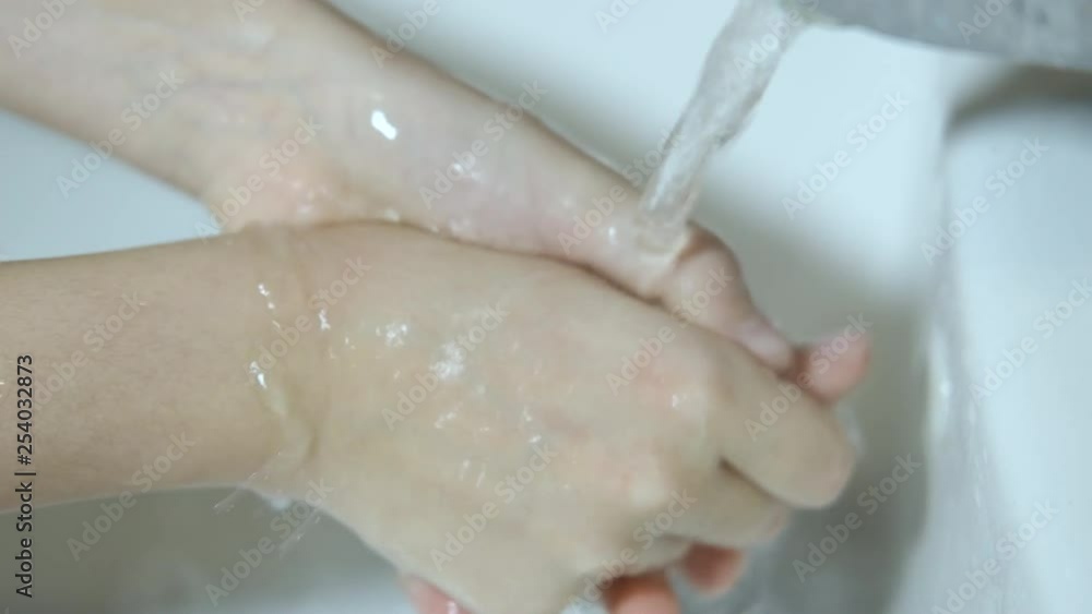 The child washes his hands. The child washes his hands under running water. The child washes his hands. The child washes his hands under running water.
