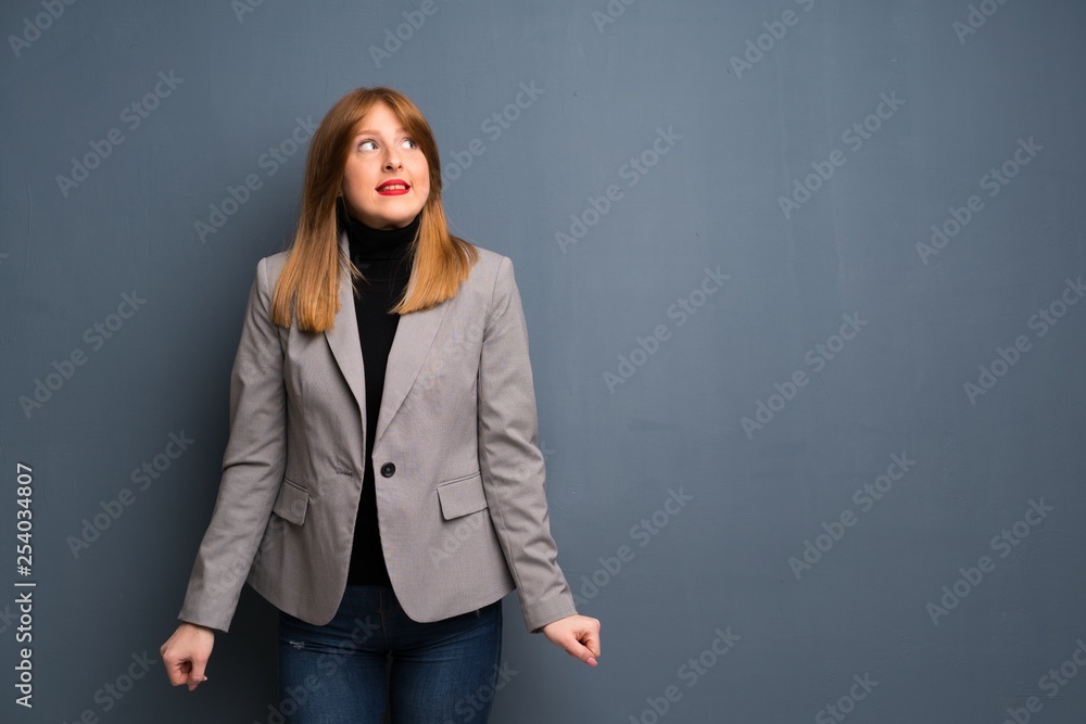 Redhead business woman is a little bit nervous and scared pressing the teeth Redhead business woman is a little bit nervous and scared pressing the teeth