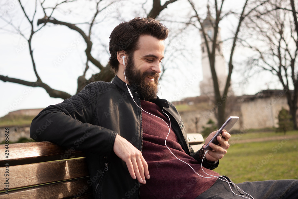 Handsome Man Using Mobile Smart Phone Outdoors Handsome Man Using Mobile Smart Phone Outdoors