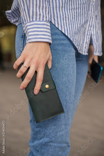 Sky blue handbag purse and beautiful woman hand with manicure