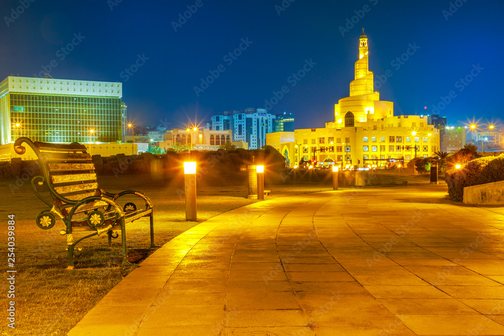 Bench and walkway in Souq Waqif Garden near Doha Corniche with Fanar