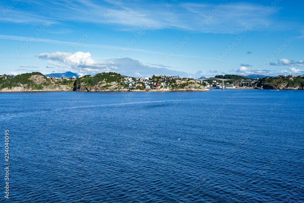 Kristiansund scenic landscape viewed from Hurtigruten cruise ship with colorful wooden houses along the coast, Norway.