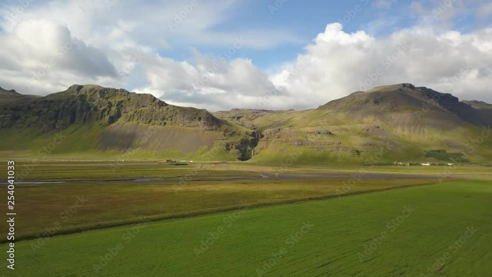 Aerial approach towards Mountains in Iceland, green landscape on sunny day. Aerial approach towards Mountains in Iceland, green landscape on sunny day.