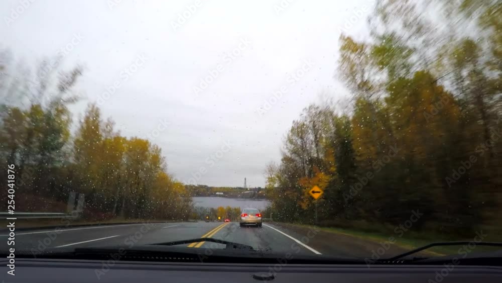 Car driving (drivers point of view) on a small city of Quebec (Shawinigan) in Canada with overcast weather and rain - autumn season. Car driving (drivers point of view) on a small city of Quebec (Shawinigan) in Canada with overcast weather and rain - autumn season.