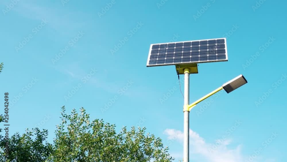 Street light working from clean solar panel eco energy on background of clear blue sky. Concept of green natural alternative resource usage. Clean and environment friendly electricity source Street light working from clean solar panel eco energy on background of clear blue sky. Concept of green natural alternative resource usage. Clean and environment friendly electricity source