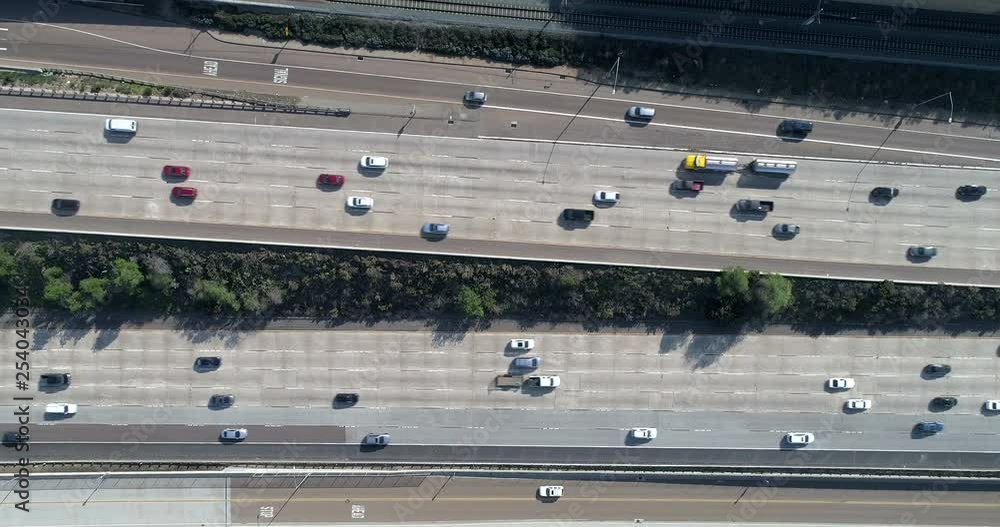 An overhead view of traffic driving by on a sunny afternoon in California. An overhead view of traffic driving by on a sunny afternoon in California.