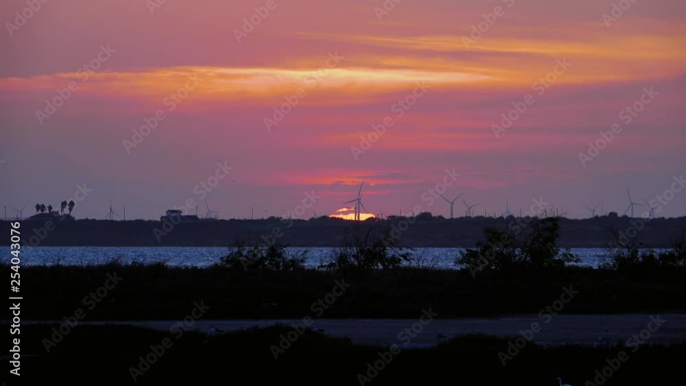 Colorful sunset at a windfarm in Texas Colorful sunset at a windfarm in Texas