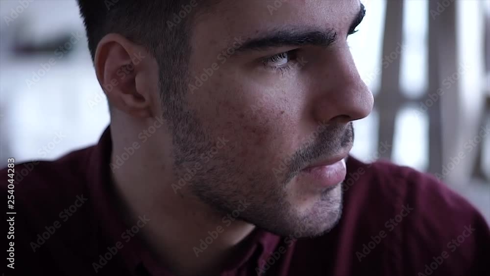 Young man looking at camera and then smiling . Portrait of a happy and serious handsome young man. Close up face of young cool trendy man looking at camera Young man looking at camera and then smiling . Portrait of a happy and serious handsome young man. Close up face of young cool trendy man looking at camera