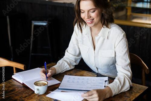 Confident businesswoman working with documents