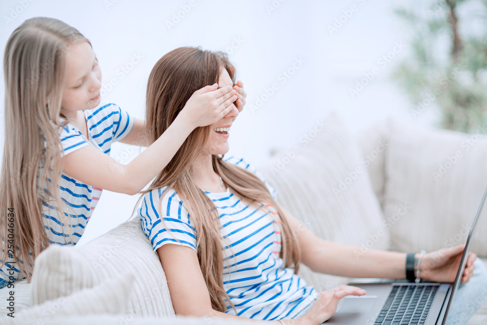 guess who. a little girl playing with her mother guess who. a little girl playing with her mother