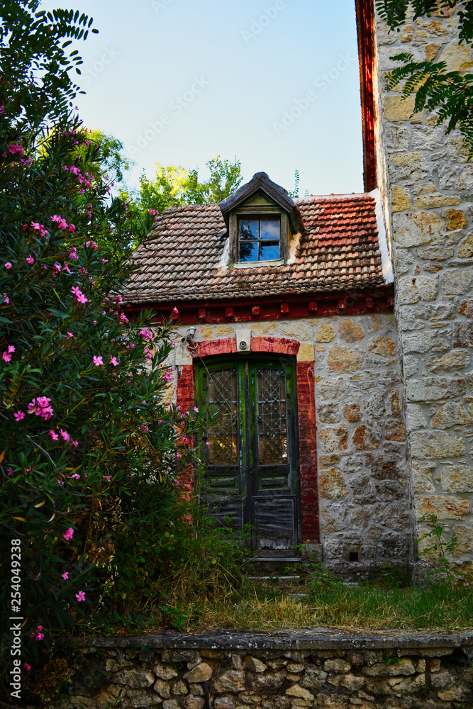 Old house with beautiful flower on the side Old house with beautiful flower on the side