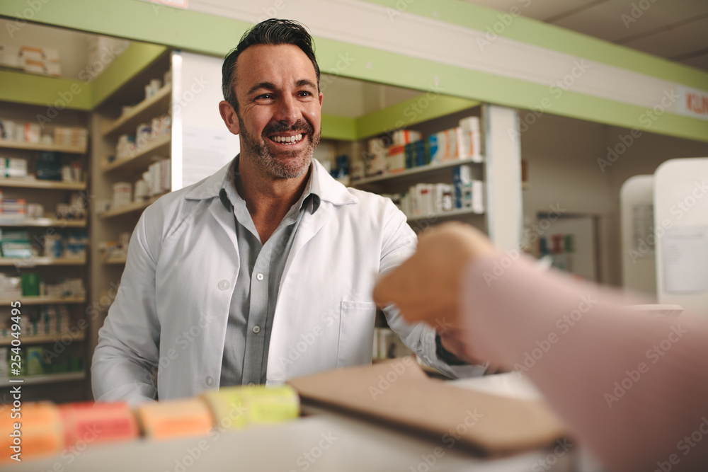 Chemist assisting customer at pharmacy store Chemist assisting customer at pharmacy store