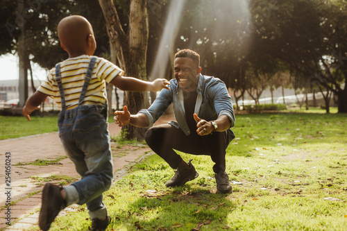 Son running into father's embrace photo