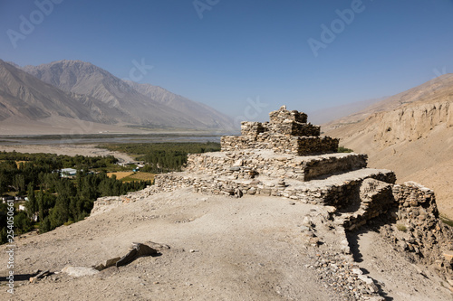 Fertile Wakhan Valley with a buddhist temple near Vrang in Tajikistan. The mountains in the background are the Hindu Kush in Afghanistan photo