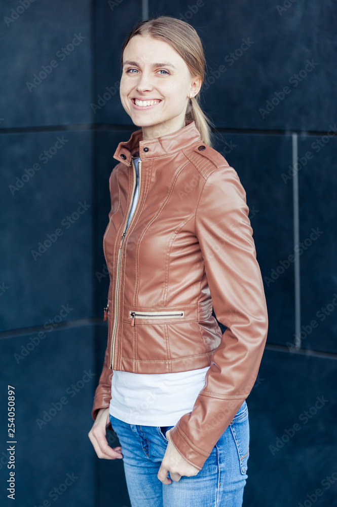 Beautiful young blonde smiling woman wearing casual outdoor Beautiful young blonde smiling woman wearing casual outdoor