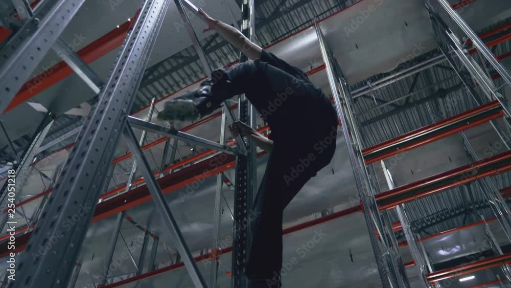 Climber without insurance on rollers in the logistics center Climber without insurance on rollers in the logistics center