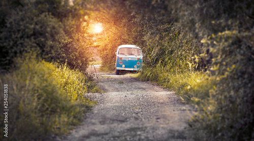 hippie bus on the road in sunset