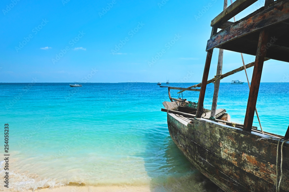 Wooden traditional ship on paradise sandy beach of Zanzibar island Indian ocean Wooden traditional ship on paradise sandy beach of Zanzibar island Indian ocean
