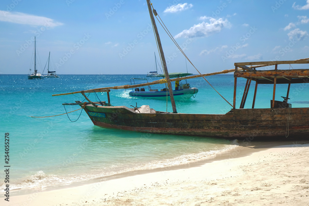 Wooden traditional ship on paradise sandy beach of Zanzibar island Indian ocean Wooden traditional ship on paradise sandy beach of Zanzibar island Indian ocean