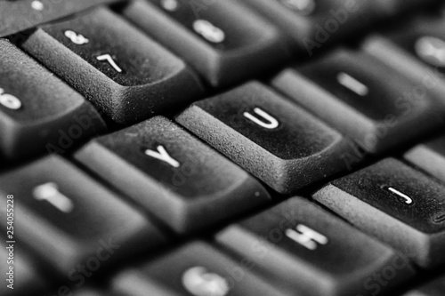 Black and white photo of a close up computer keys with letters from a pc keyboard