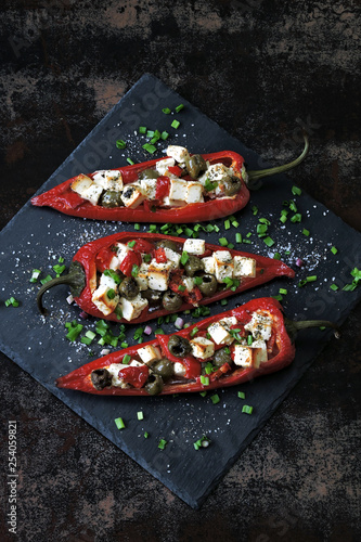 Baked red paprika stuffed with feta and olives. Keto diet. Keto recipe. Vegetarian lunch idea.