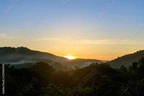 Tropical forest mountain with fog and mist in morning during sun rise at Hang Dong district in Chiang Mai, Thailand