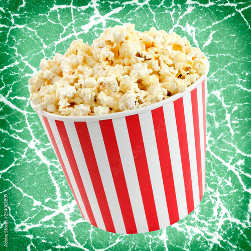 Popcorn in red and white cardboard box for cinema or TV