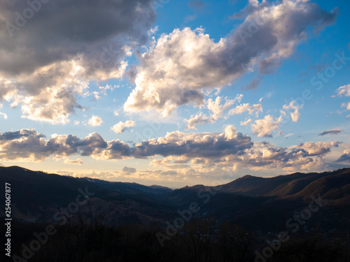 Beautiful landscape in the mountains at sunset. View of colorful sky with amazing clouds. © HAOS