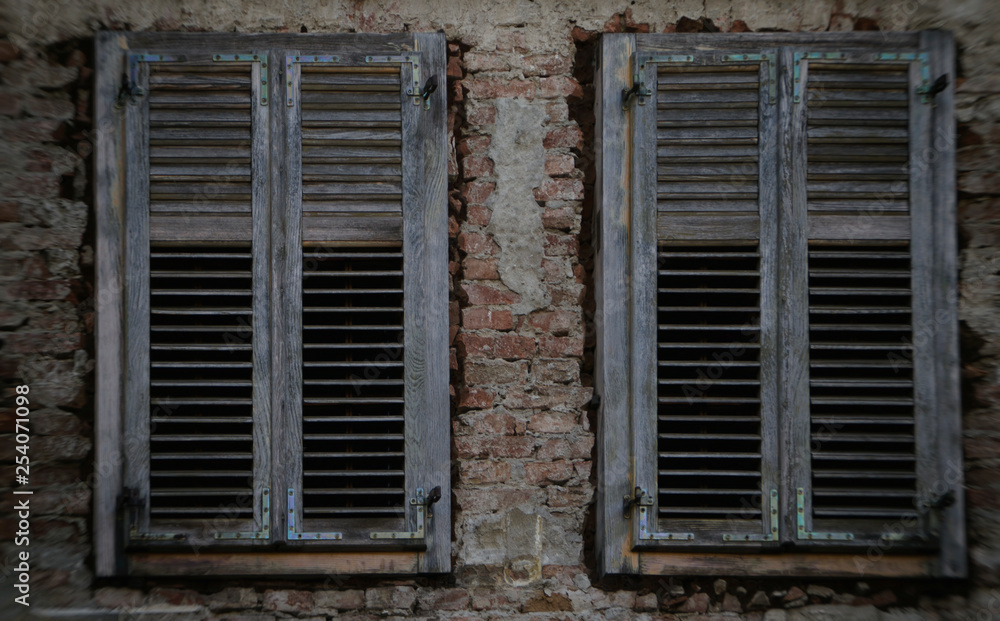 An old wooden window on an old brick house. An old wooden window on an old brick house.