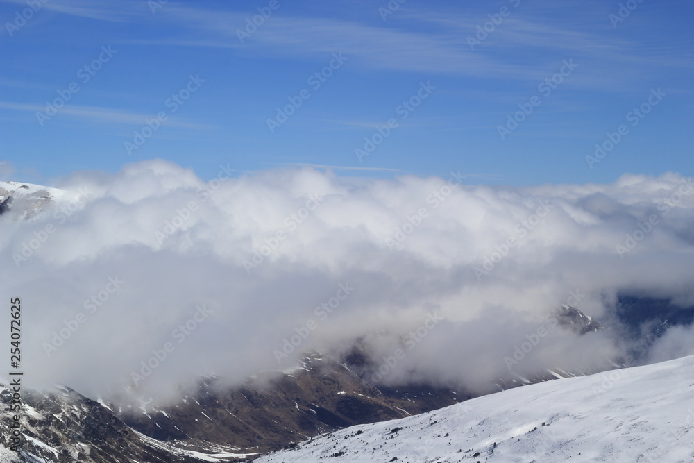 Mountain peaks over clouds.