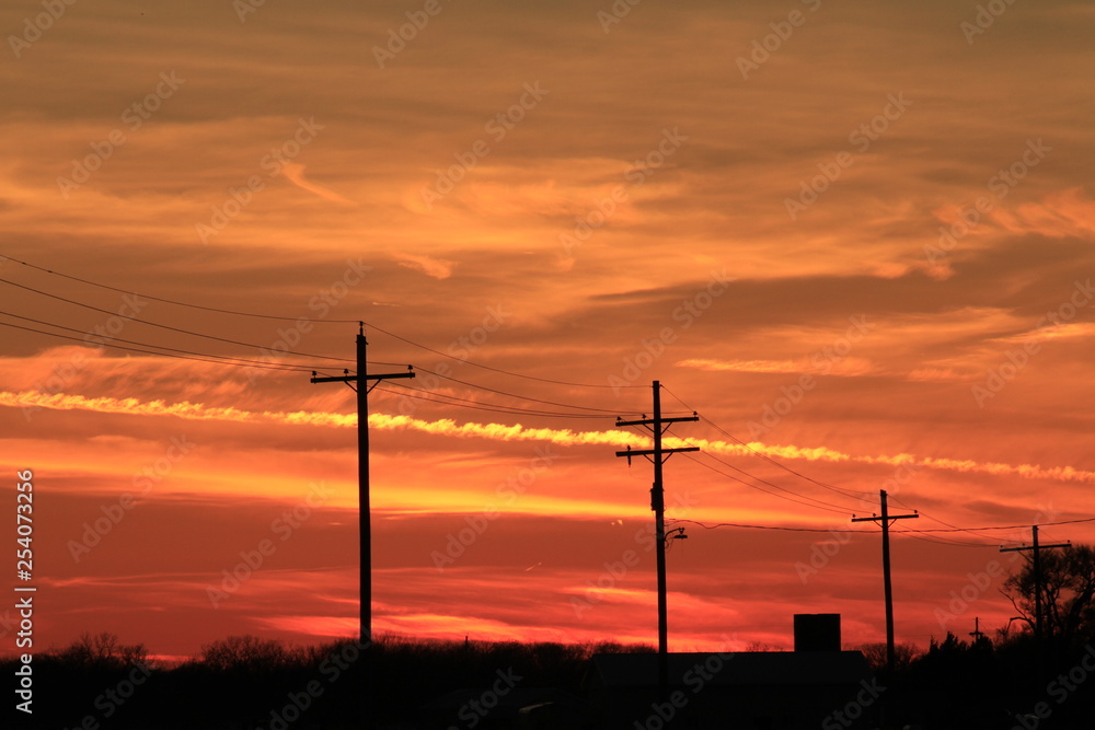 Sunset with power lines silhouettes with a colorful sky.