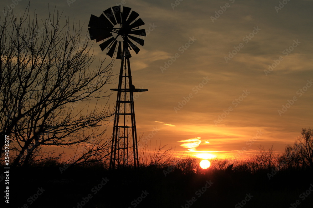 Kansas Windmill Silhouette with clouds and tree