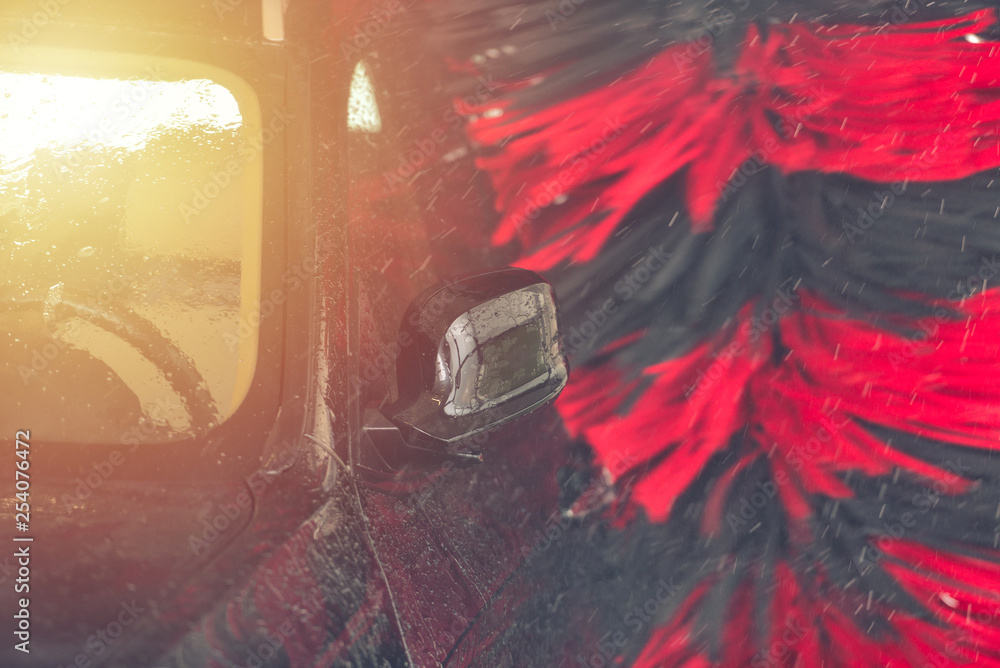 Automatic car wash in action. Car wash concept. Automated technology ... Car auto wash machine