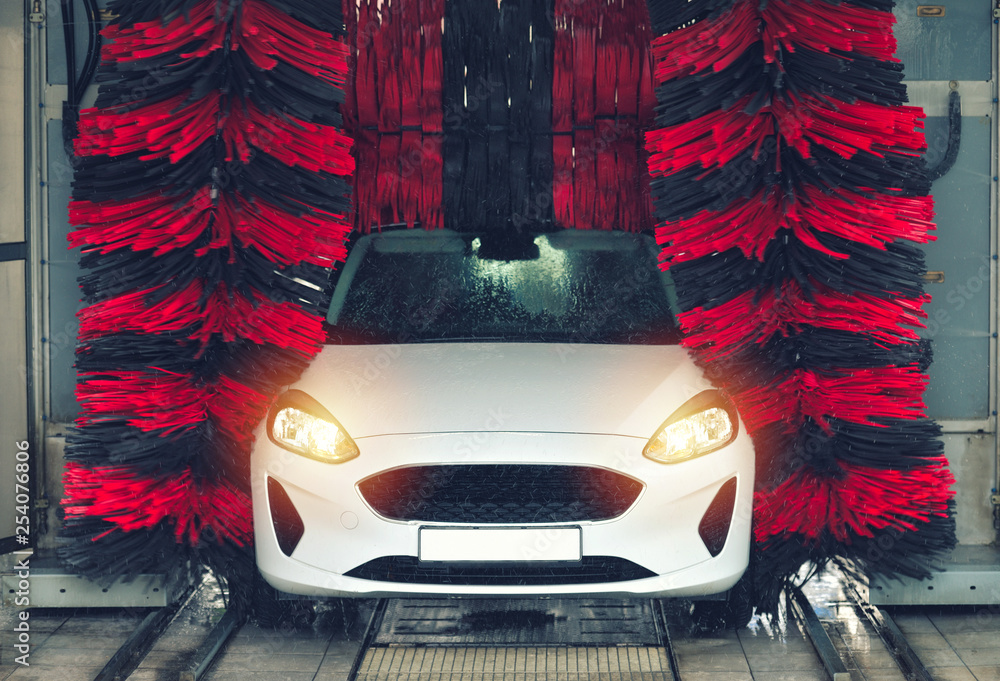 Automatic car wash in action. Car wash concept. Automated technology