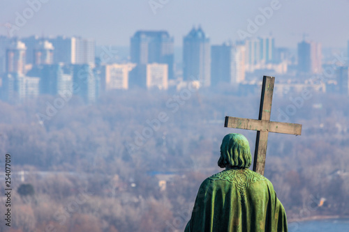 Early spring at sunny evening in warm weather. Monument of St. Volodymyr. Eastern suburbs of Kyiv, residential areas Livoberezhny, Bereznyaky on the left bank of the Dnipro River. Ukraine Mar. 6, 2019 photo