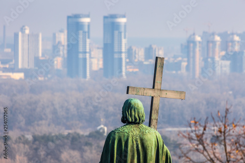 Early spring at sunny evening in warm weather. Monument of St. Volodymyr. Eastern suburbs of Kyiv, residential areas Livoberezhny, Bereznyaky on the left bank of the Dnipro River. Ukraine Mar. 6, 2019 photo