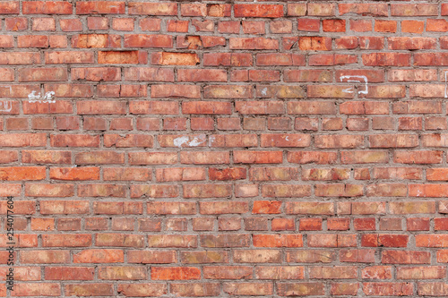 Old brick wall with scratches  cracks  dust  crevices  roughness. Can be used as a poster or background for design.