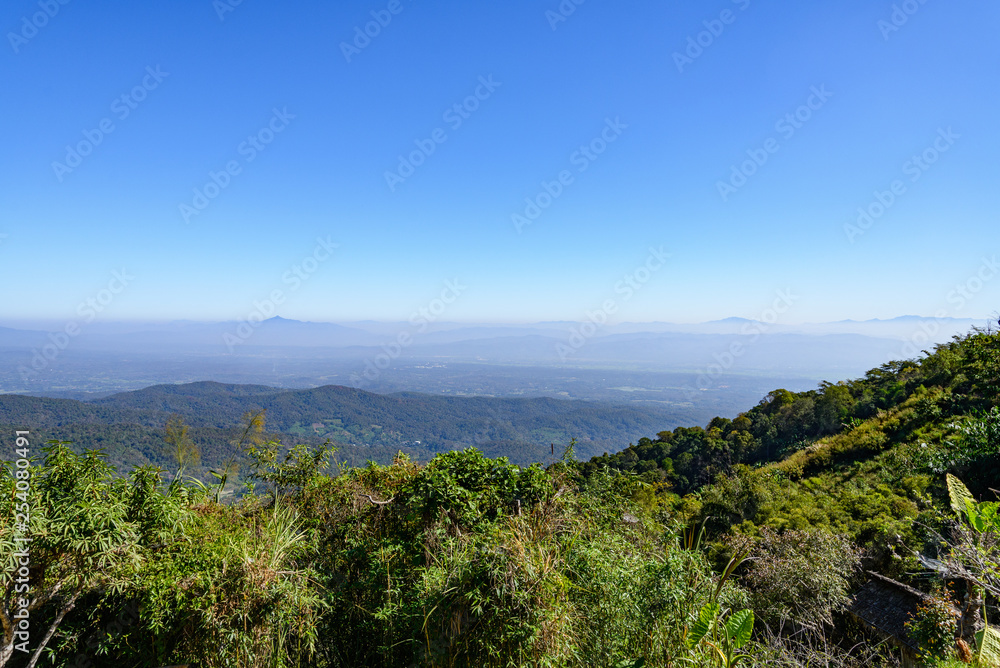 Outdoor sunshine scenery range of mountain at Mon Chame, famous mountaintop in Chiang Mai, Thailand. Tranquility and retreat spot on the peak over tropical rain forest.