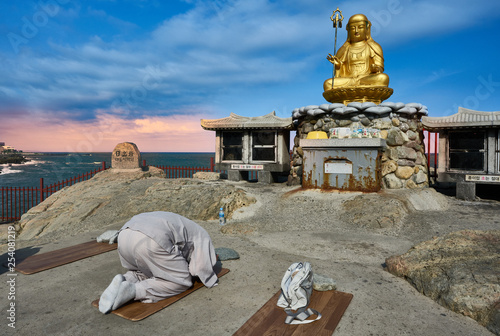 A prayer at Haedong Yonggungsa Temple, Busan, South Korea photo